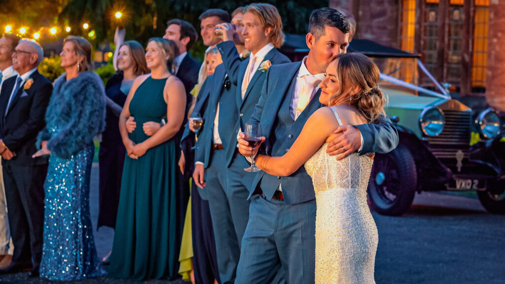 A happy wedding couple watching their wedding fireworks at Wrenbury Hall, Cheshire.
