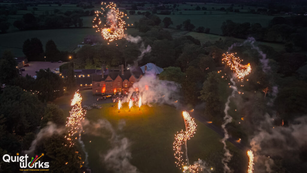 Dramatic drone shot from inside a firework display above Wrenbury Hall Wedding Venue, Cheshire. 
